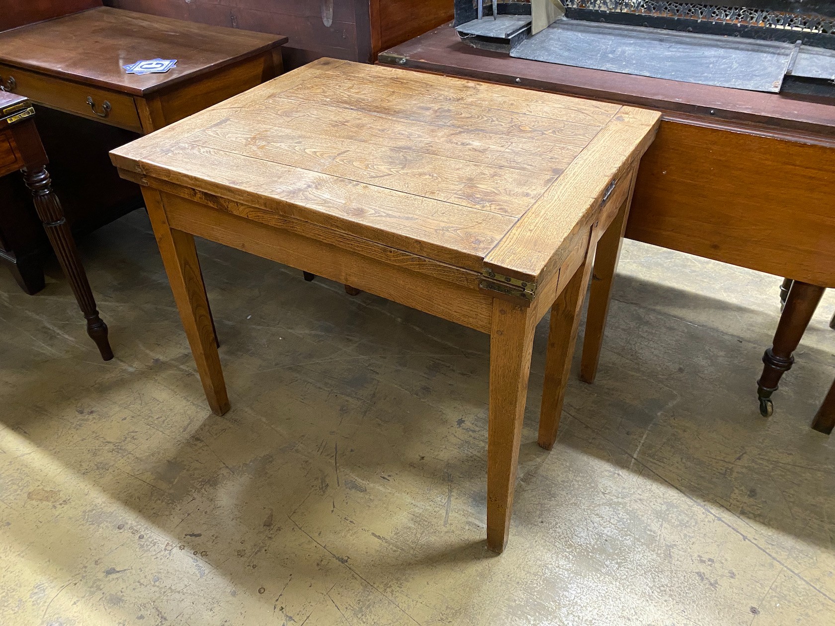 A 19th century French provincial oak farmhouse table with rectangular folding top on square tapered legs, 176cm extended, depth 69cm, height 74cm
